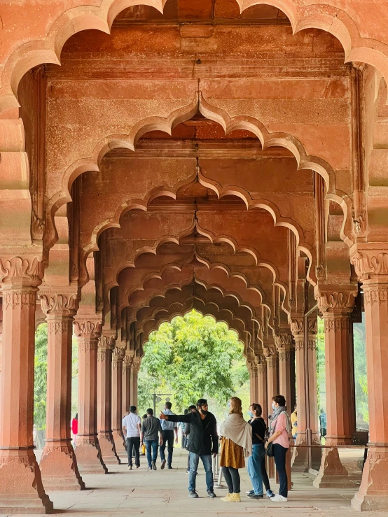 a large brick archway with people walking underneath it