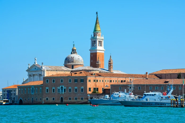 the boats are docked near the old buildings