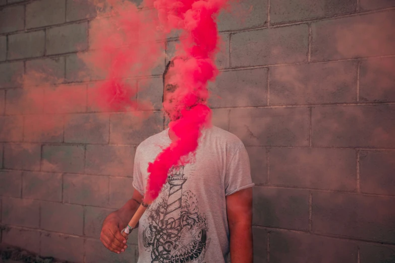 a man is smoking a red cigarette on the wall