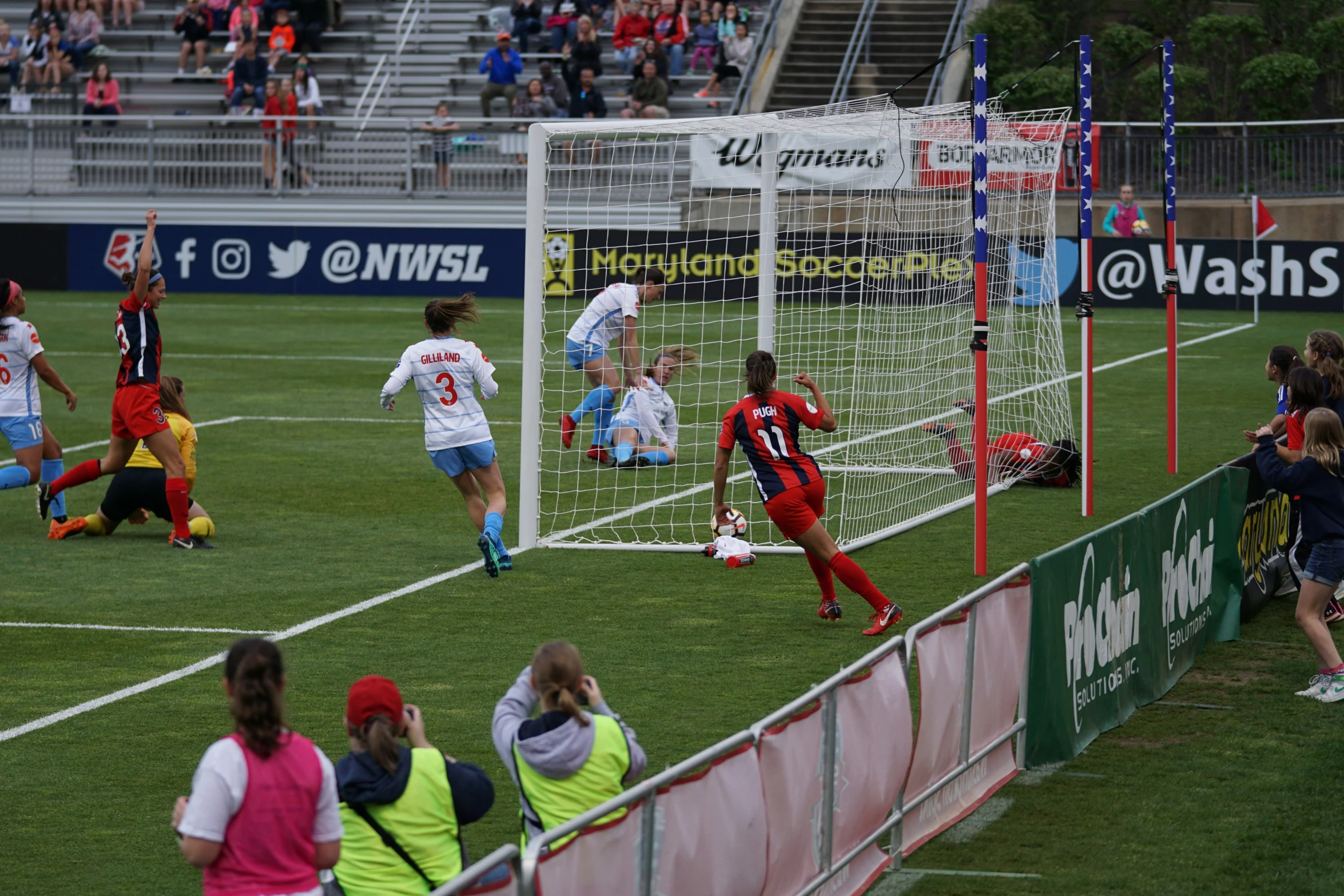 a group of people standing on top of a soccer field