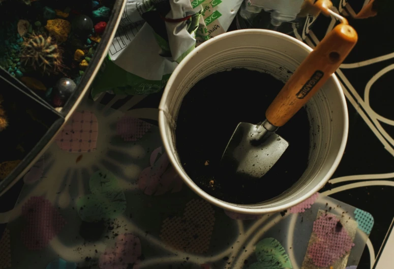 the brush is inside a small bucket that sits on a table