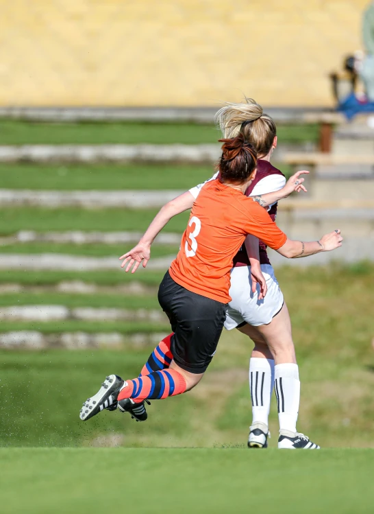 two girls on the soccer field playing soccer