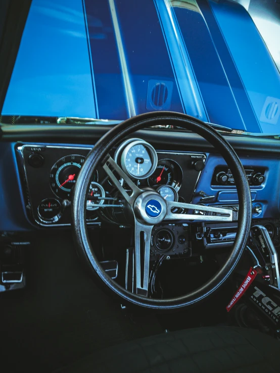 an old car dashboard with a steering wheel