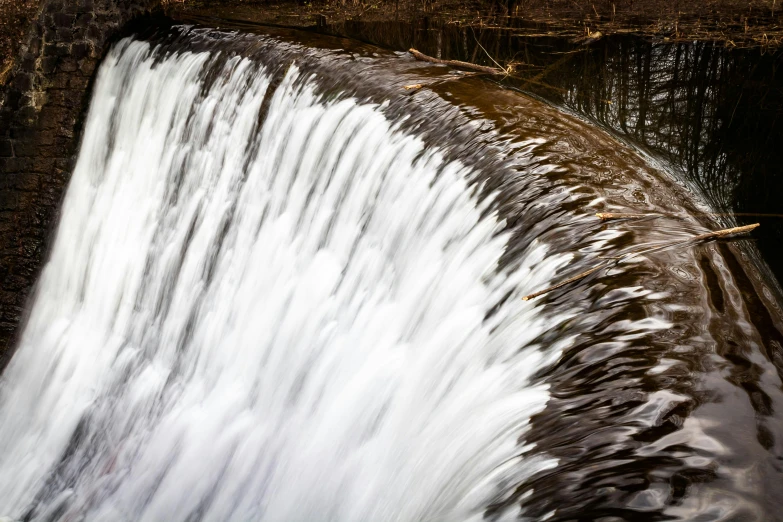 water coming down the side of a dam