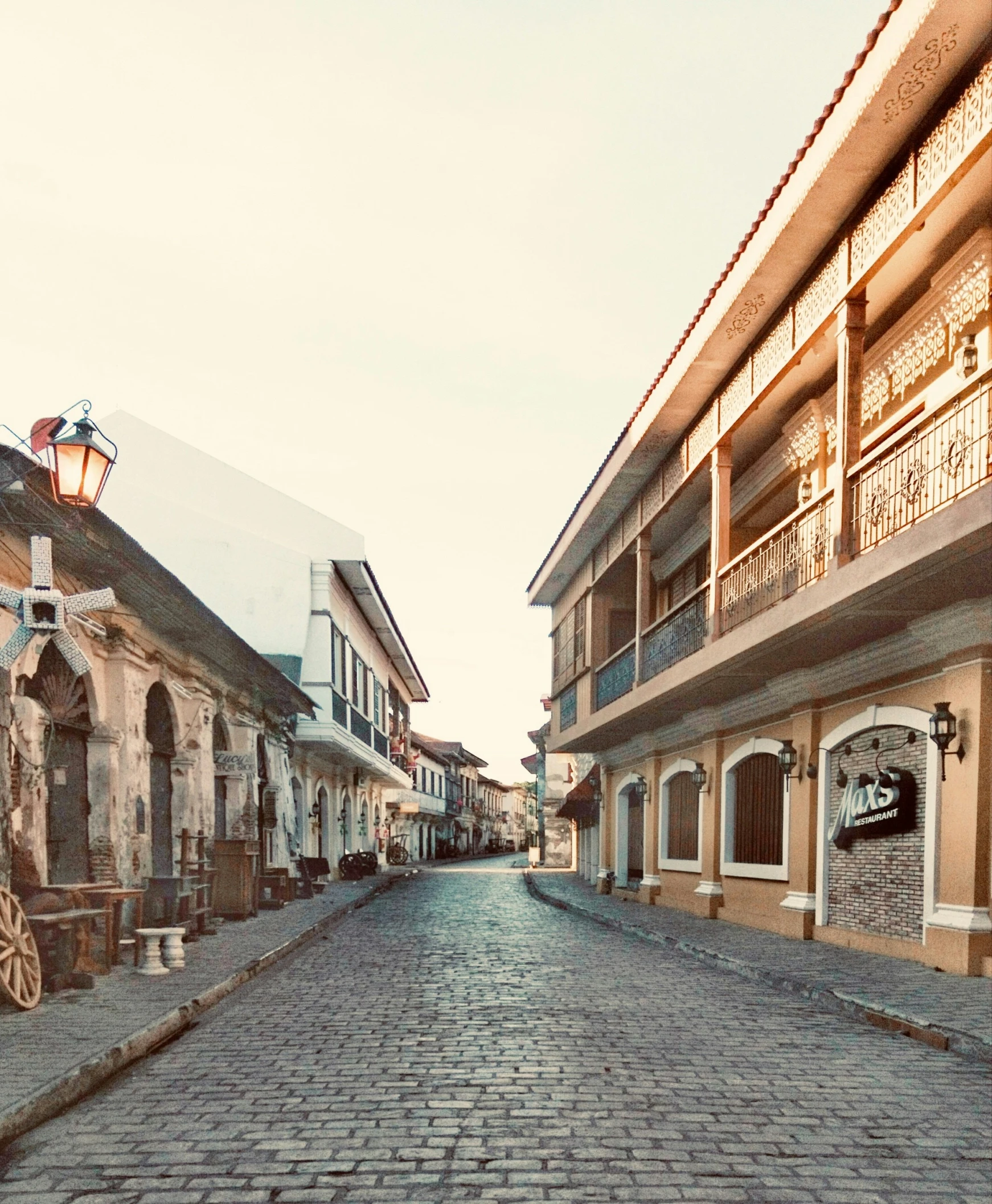 a cobblestone street lined with historic buildings