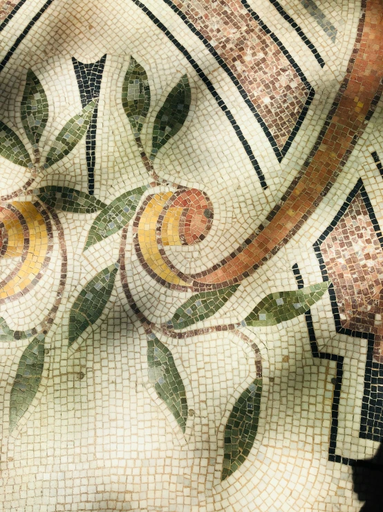 closeup of mosaic work depicting flowers and a circular motif