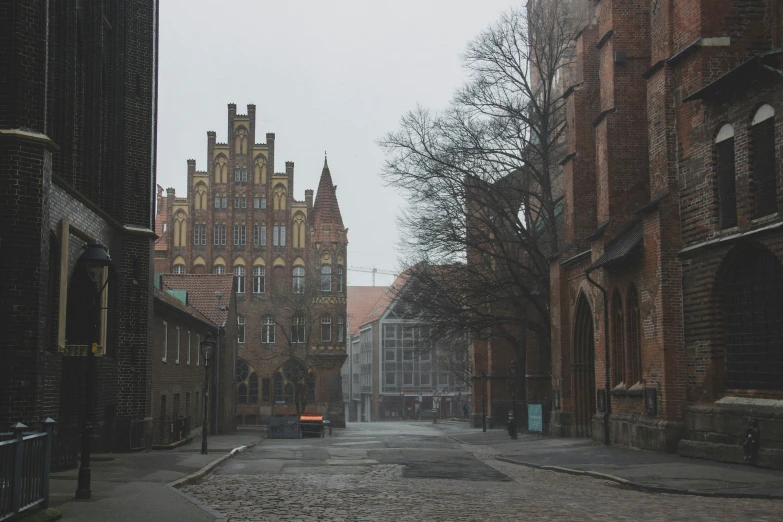 old brick buildings with windows and a clock tower in the background