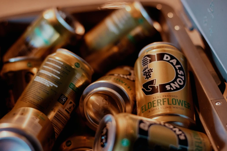 several cans of beer in a metal container