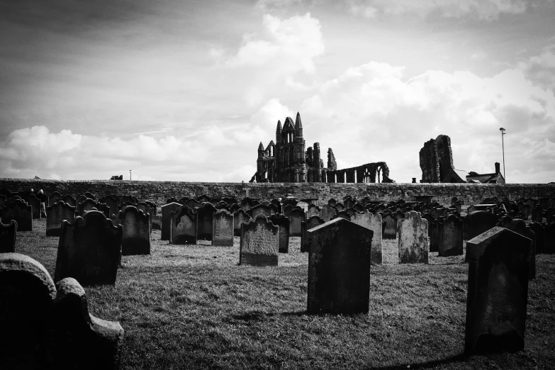 a group of people standing in a cemetery