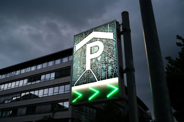 a large parking sign with neon letters attached to it