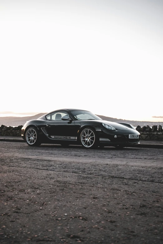 the very attractive and sleek sports car parked on the side of a road