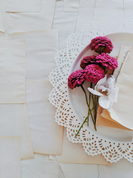 some very pretty flowers on a doily