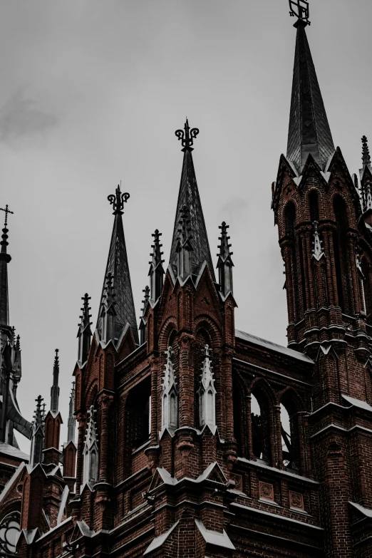 the spires of buildings are covered with snow