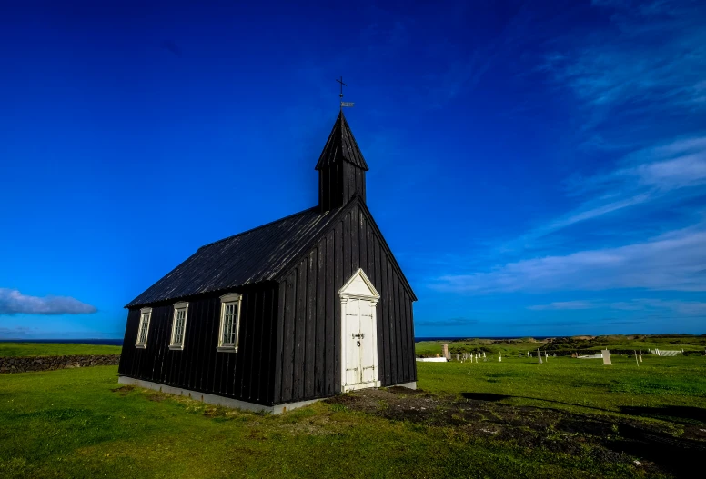 an old, small church stands out against the blue sky