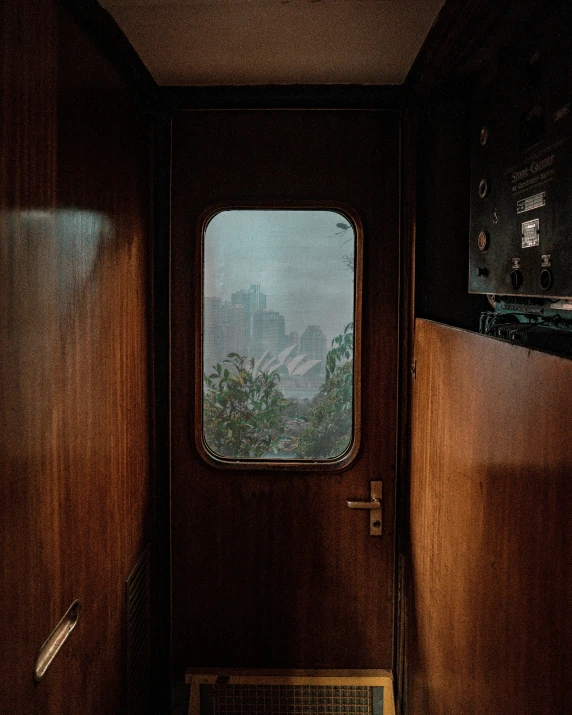 a wooden bench sitting in front of a window