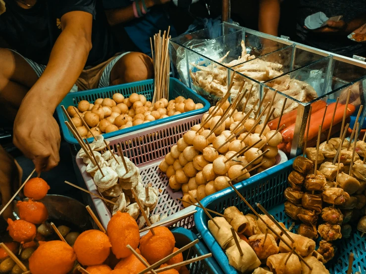 a large variety of foods and people behind them