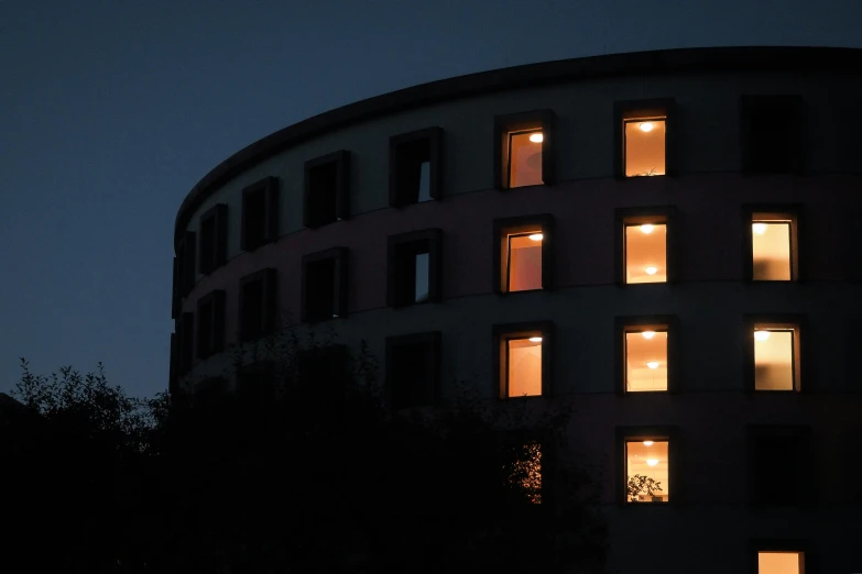 a building with many windows that has lights on