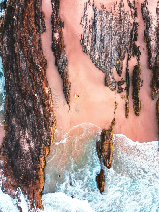 the sandy beach with waves splashing around it