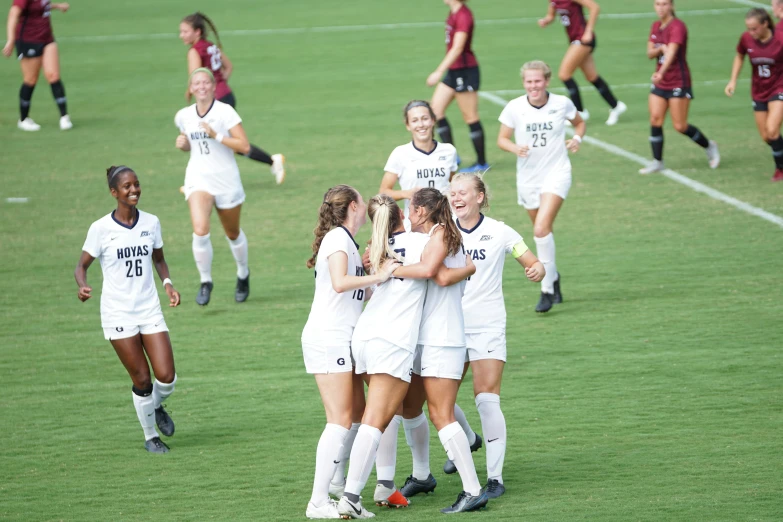 a soccer team celetes with their arms around each other