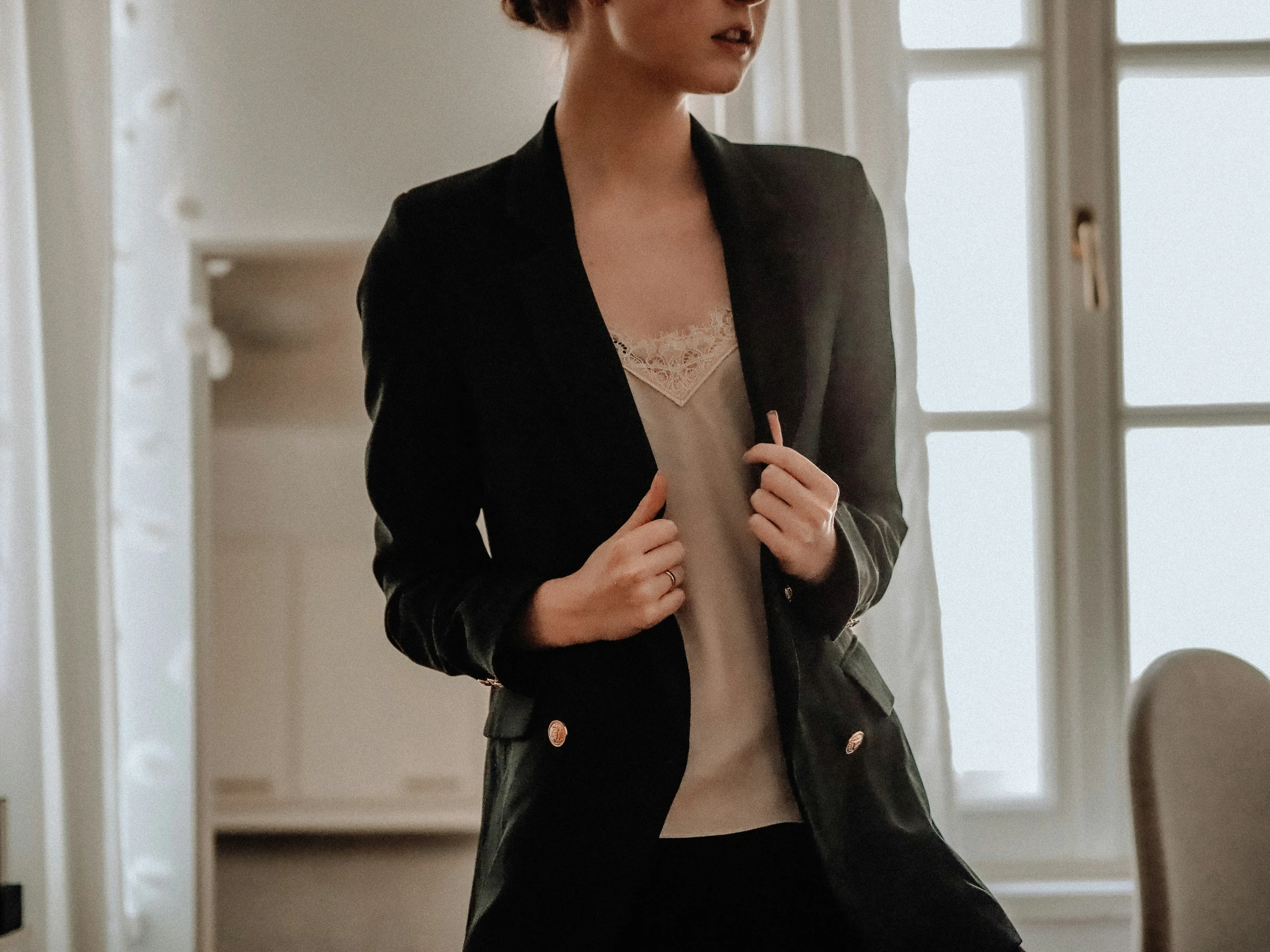 a woman in black blazer and pants standing