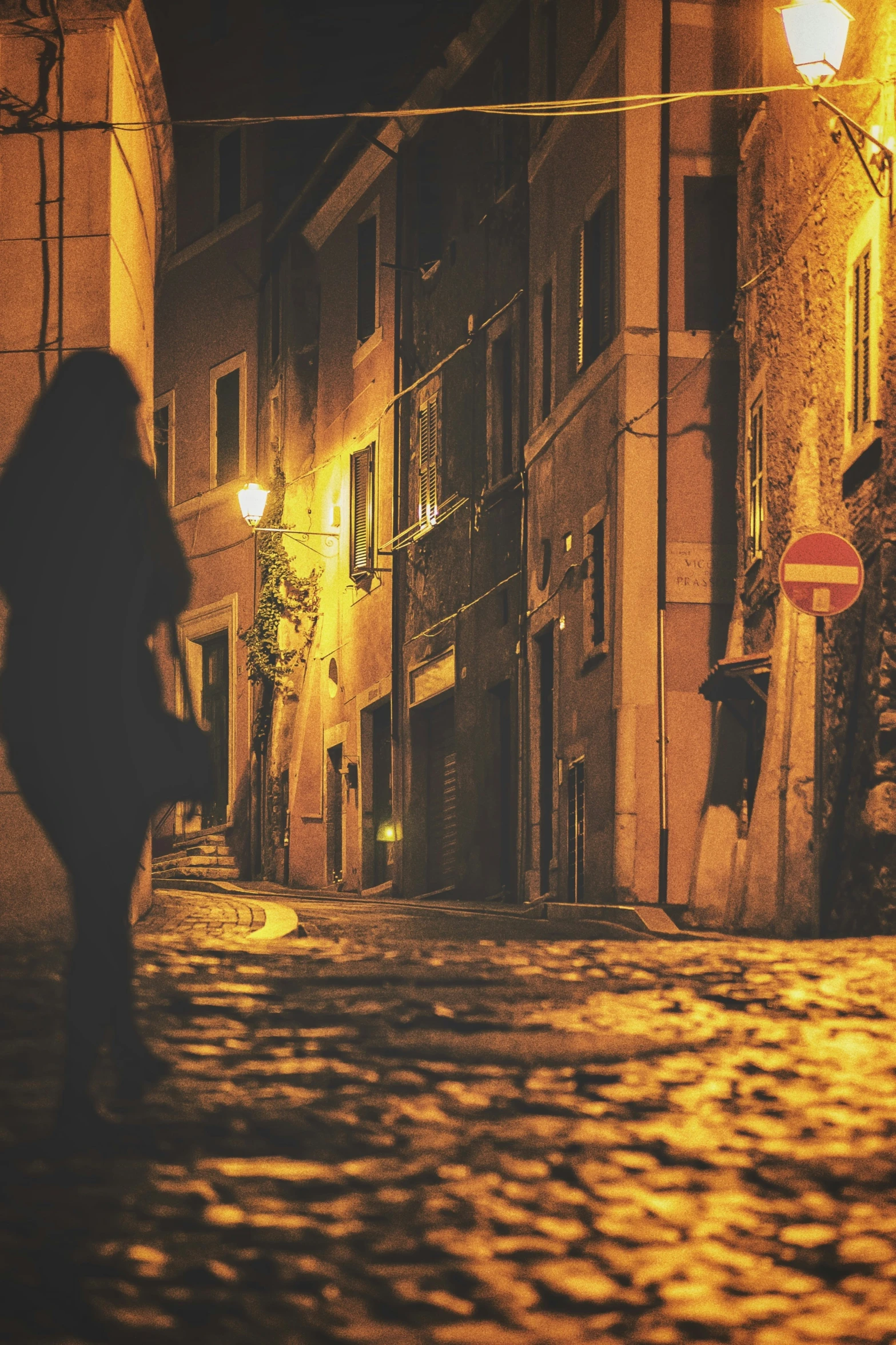 person walking along the streets at night