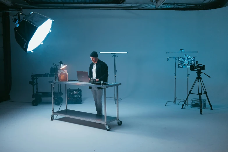 two spotlights behind a pographer taking a po of a male