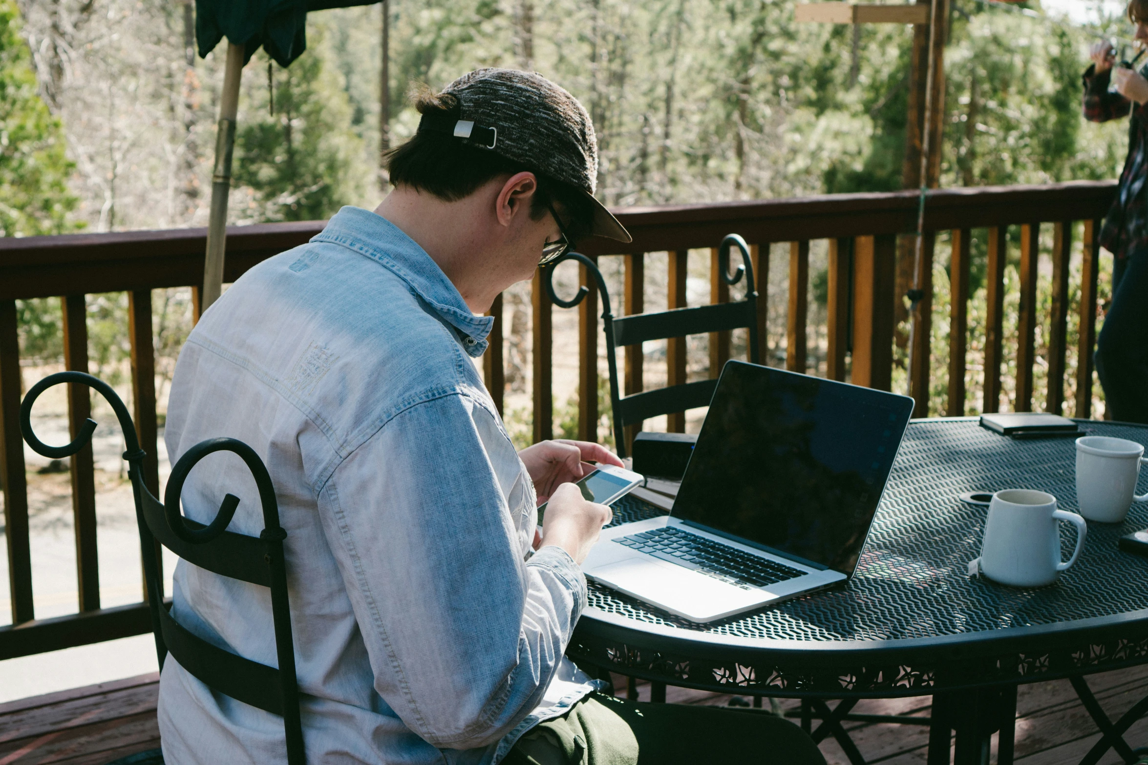 a man sitting at a table using a laptop computer