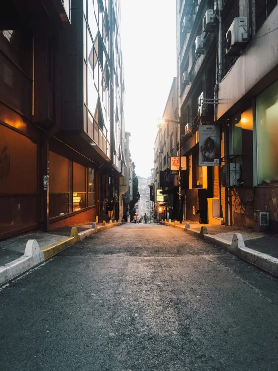 a very quiet city street during the day with only lights