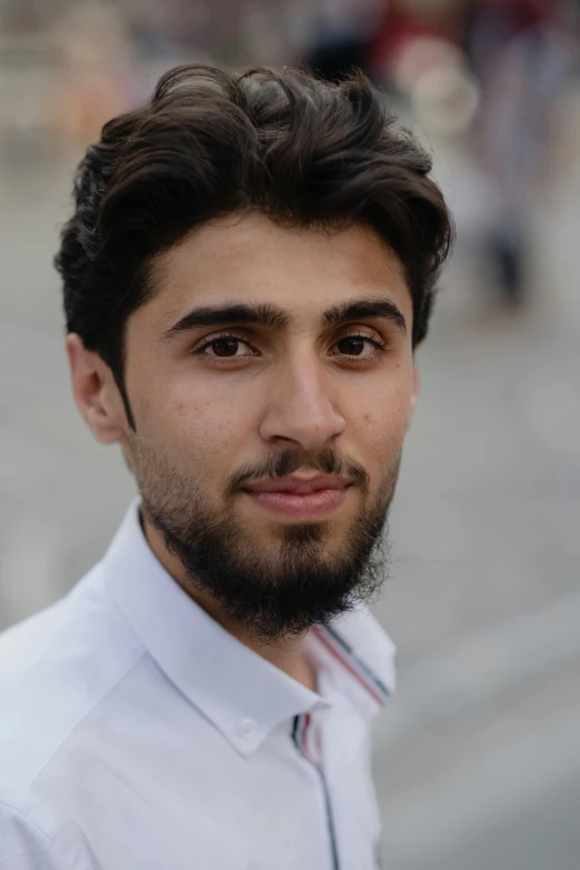 a man with a beard is posing for the camera