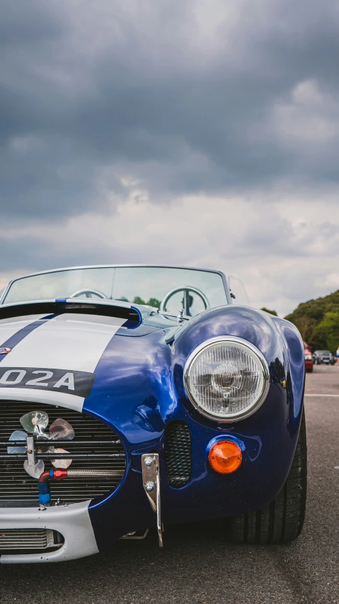 a blue car sits with white stripes on it