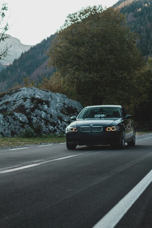 car driving down a mountain road with low traffic