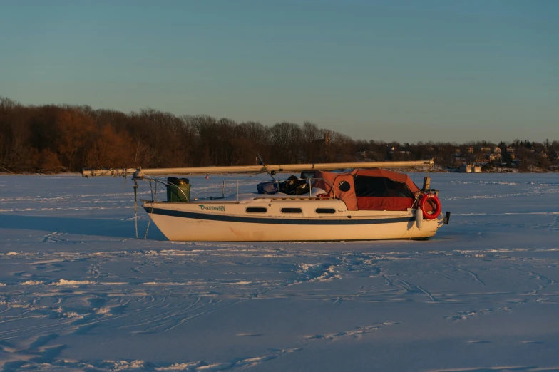 a small boat in the middle of some snow