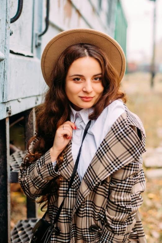 a young woman posing for the camera with her hand on her shoulder