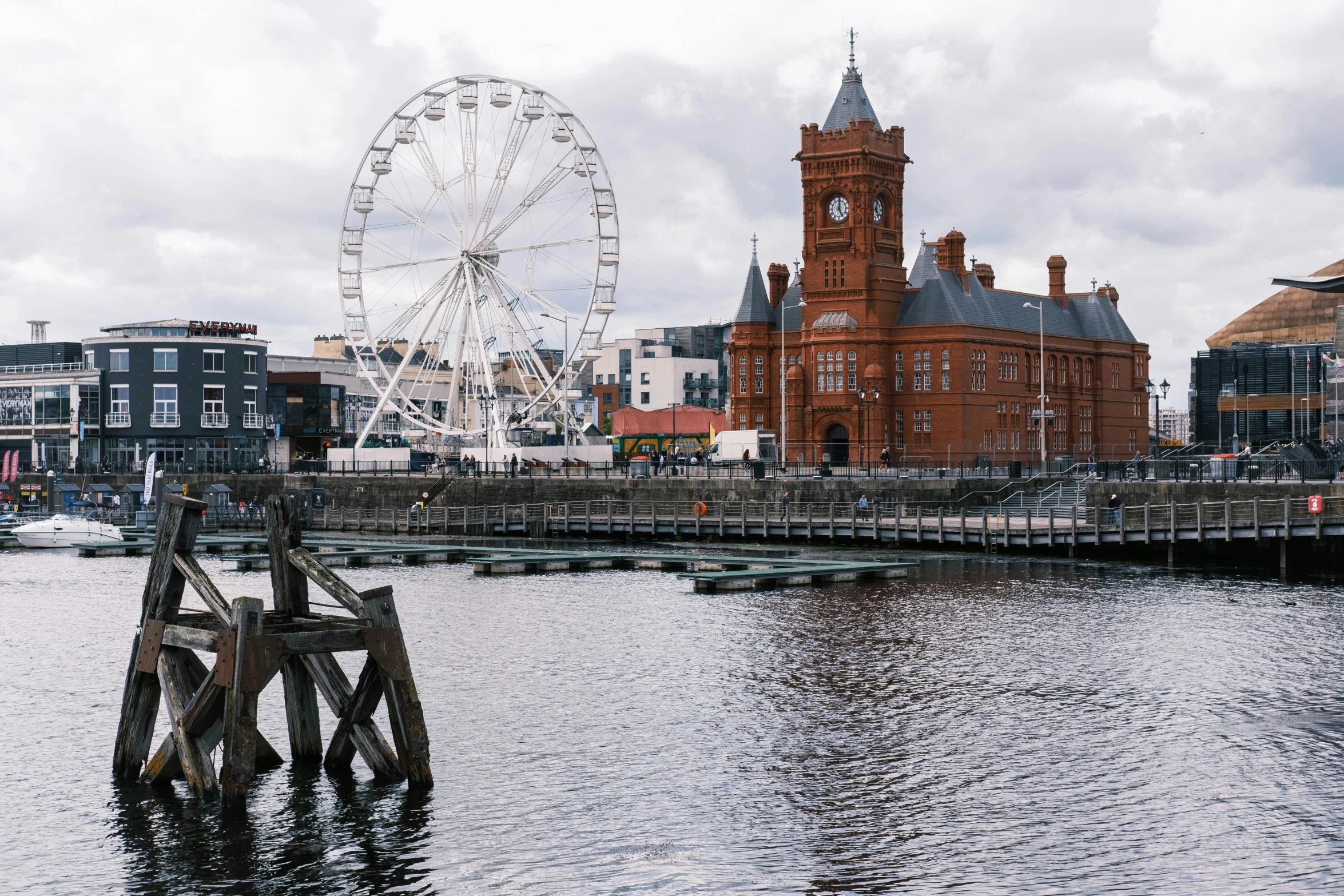 a large building sitting on top of a pier next to water