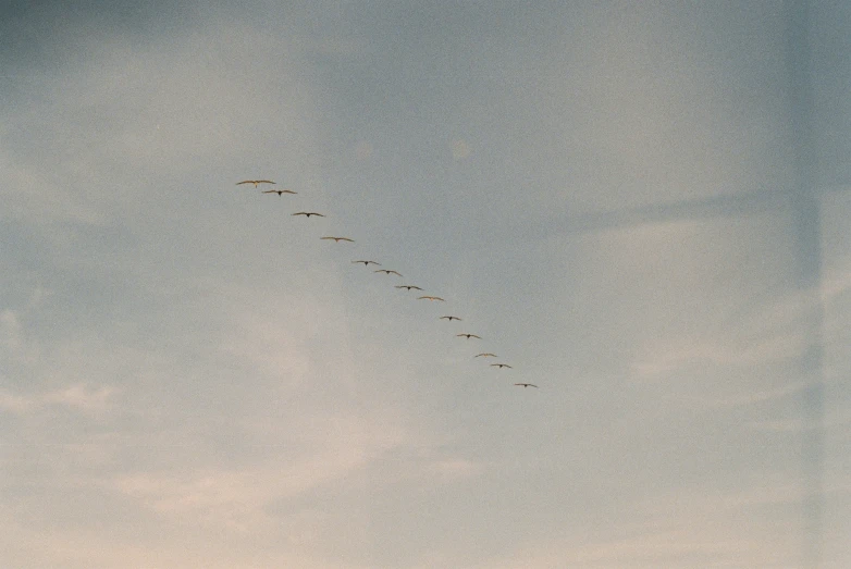 a very long line of planes flying in the sky