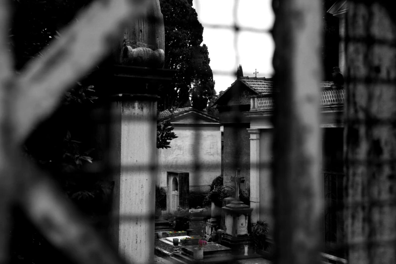 a small cemetery seen through the fence