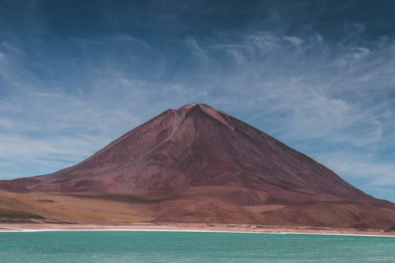 a hill with some clouds above it