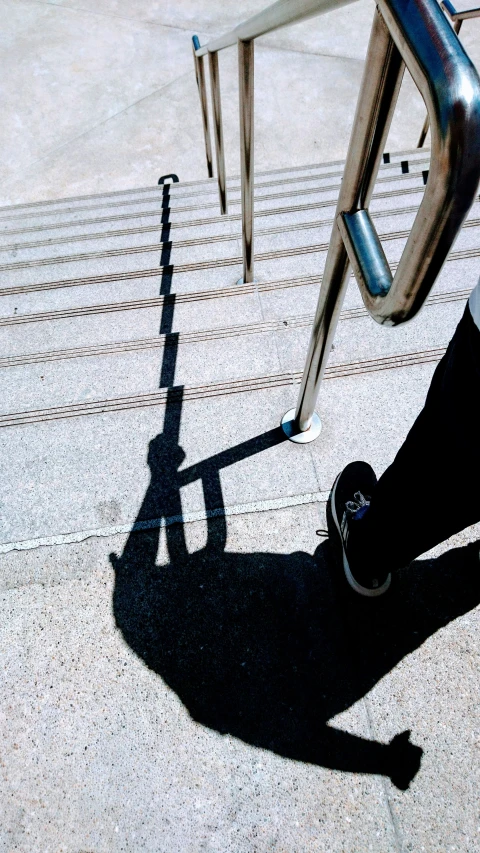 this po shows the shadow of a person riding a skateboard