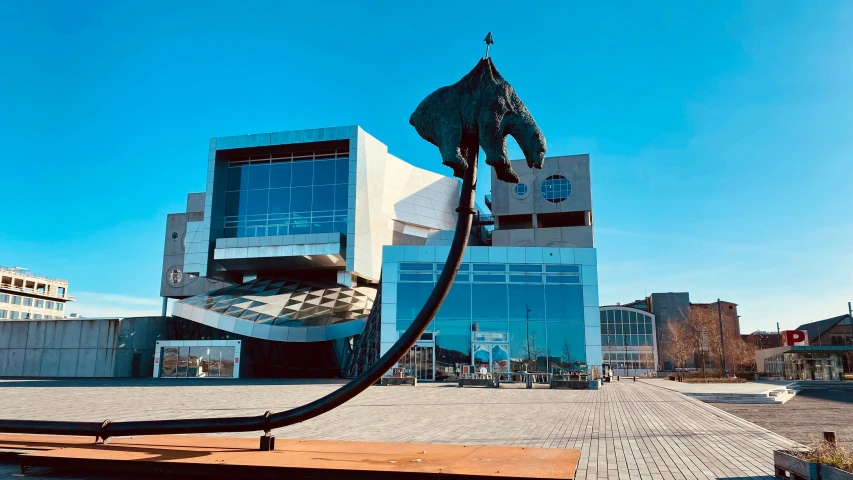 a sculpture of an elephant near a blue building