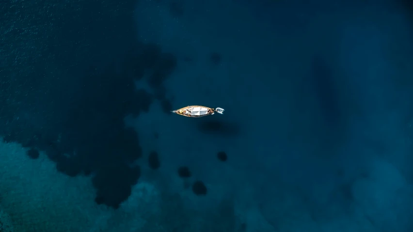 an aerial view of a boat in the water