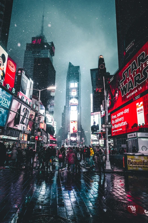 people walk in the snow on a rainy day