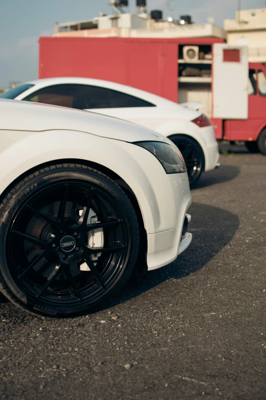 the front wheels and tires of a white sports car