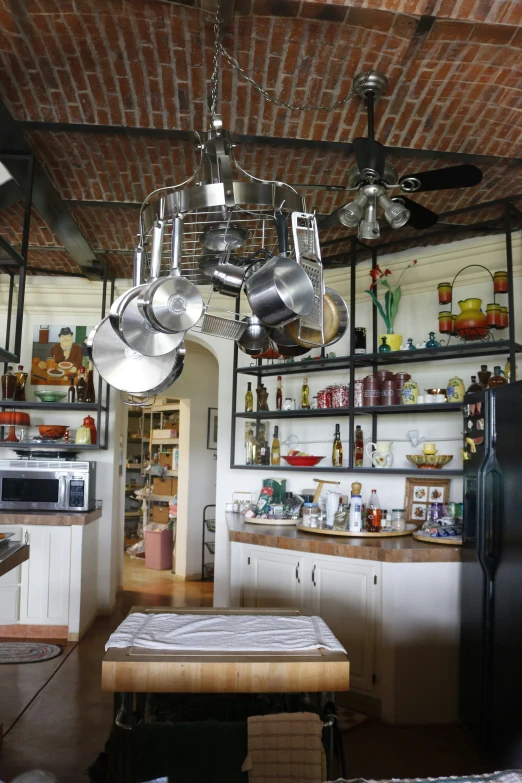 a kitchen with brick ceiling and white walls