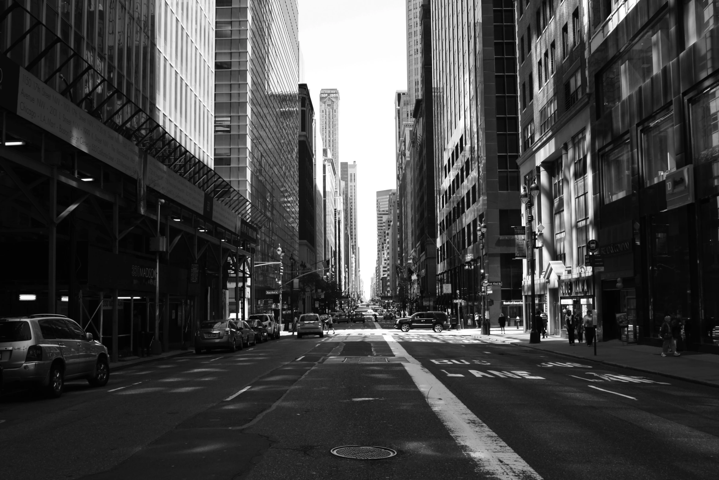 black and white pograph of an empty street with skyscrs in the distance