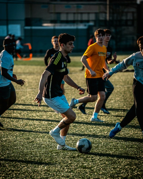 several people on field playing soccer on a cloudy day