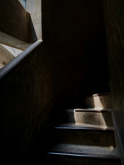 an old stone staircase has light streaming in