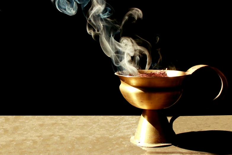 a cup with smoke and straw in it