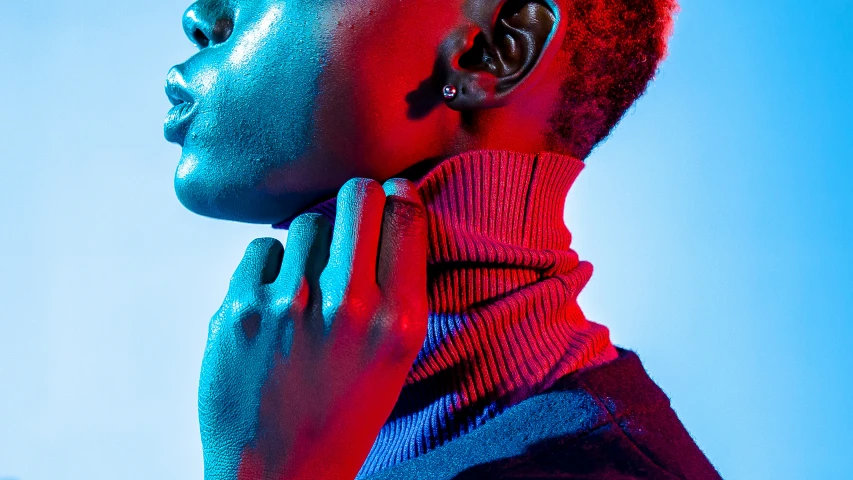 woman in red shirt and necktie standing with blue sky