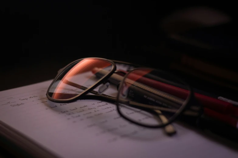 a close - up of glasses and a book