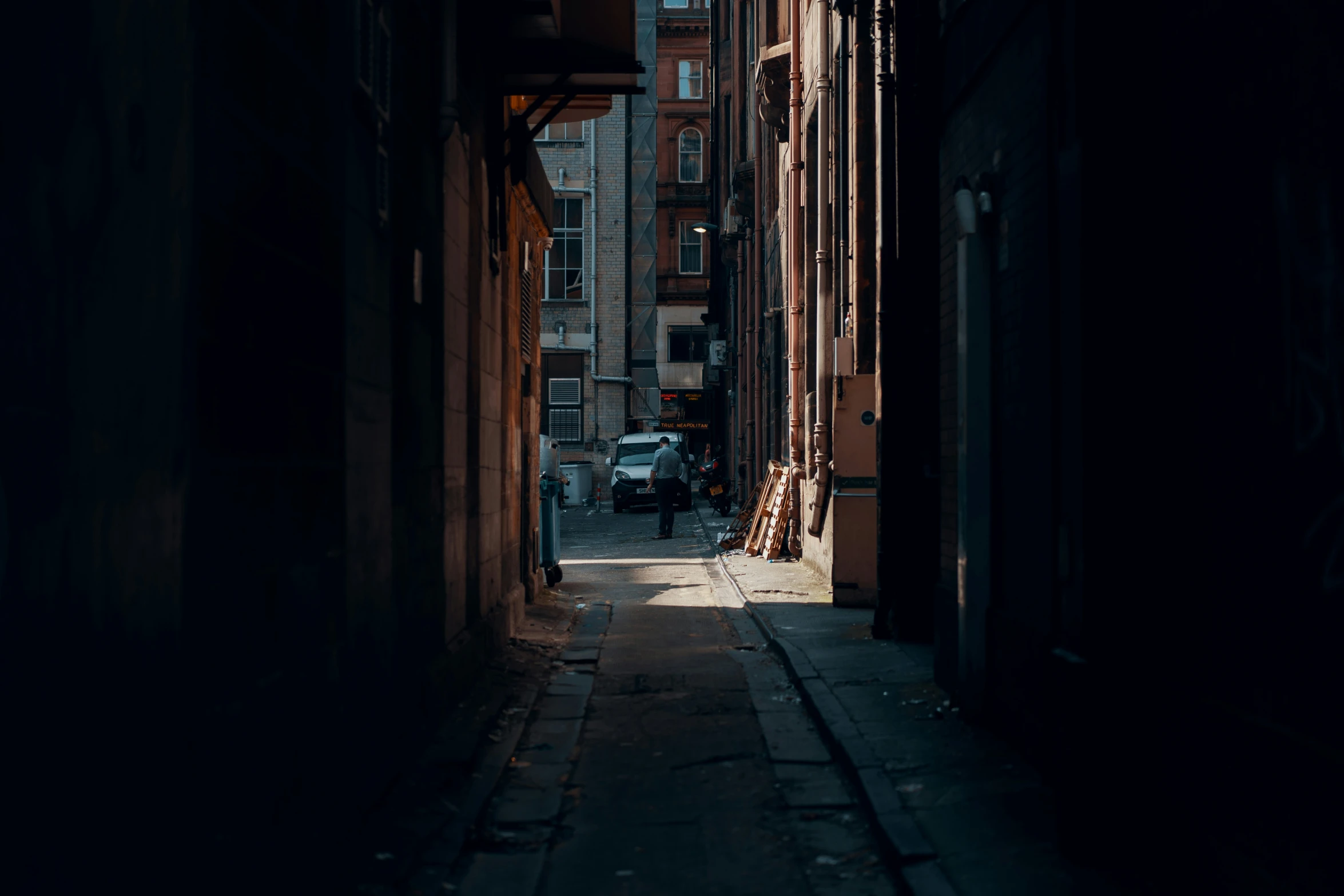 an alley with buildings in the dark